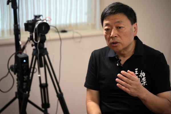 FILE- Wang Zhi'an speaks during an interview with the Associated Press in Tokyo on Oct. 5, 2022. Wang, as well as artist-turned-dissident Li Ying, said in separate posts Sunday, Feb. 25, 2024, that police were interrogating people who followed them on social media, and urged followers to take precautions such as unfollowing their accounts, changing their usernames, avoiding Chinese-made phones and preparing for to be questioned.(AP Photo/Eugene Hoshiko, File)
