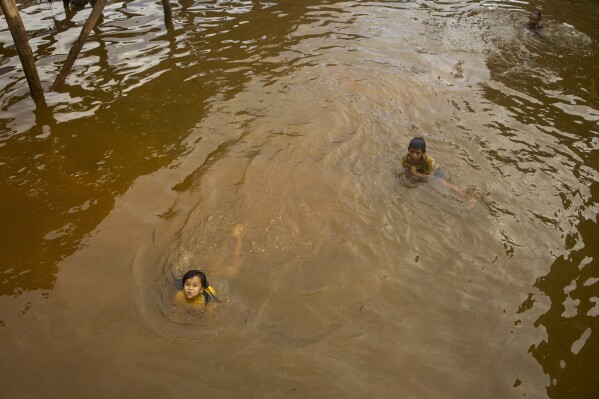 Children play in the water on Kabaena Island, Indonesia, Friday, Nov. 15, 2024. (AP Photo/Yusuf Wahil)
