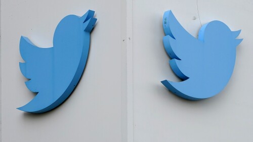 FILE - Twitter logos hang outside the company's offices in San Francisco, on Dec. 19, 2022. Australia's online safety watchdog has on Thursday, June 22, 2023, issued a legal notice to Twitter demanding an explanation of what the social media giant is doing to tackle a surge in online hate since Tesla CEO Elon Musk bought the platform. (AP Photo/Jeff Chiu, File)