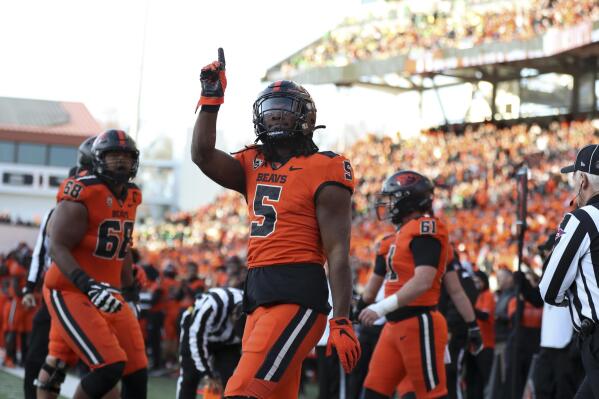 Oregon State running back Deshaun Fenwick (5) celebrates after scoring a touchdown against Oregon during the second half of an NCAA college football game on Saturday, Nov 26, 2022, in Corvallis, Ore. (AP Photo/Amanda Loman)