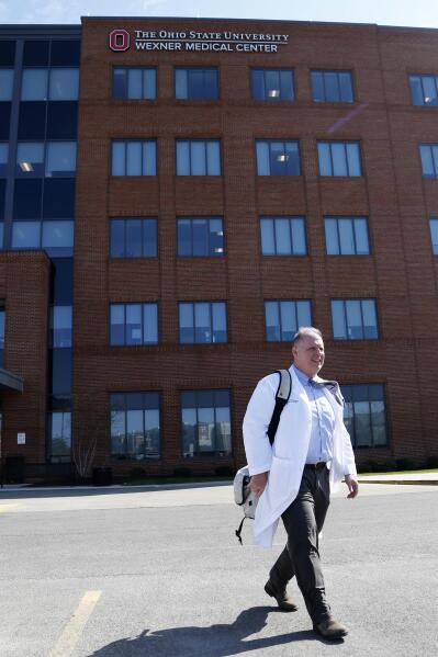 Dr. Michael Cackovic, an OB/GYN who works at Ohio State University’s Wexner Medical Center, walks through the parking lot of the Ohio State Outpatient Care facility Friday, April 23, 2021, in Upper Arlington, Ohio. When Republican lawmakers across the U.S. kept passing bans on abortion at what they term “the first detectable fetal heartbeat,” he was exasperated. Yet bans pegged to the “fetal heartbeat” concept have been signed into law in 12 states, including Cackovic’s home state of Ohio, with another awaiting a governor’s signature. (AP Photo/Jay LaPrete)