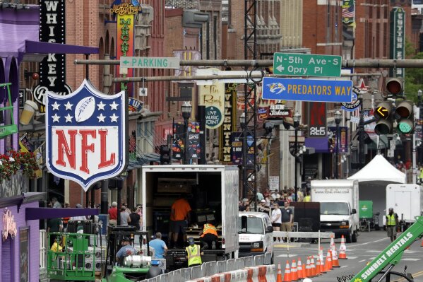 
              A temporary NFL neon sign joins the permanent ones along Broadway as preparation continues for the NFL Draft Tuesday, April 23, 2019, in Nashville, Tenn. The NFL Draft is scheduled to be held Thursday through Saturday. (AP Photo/Mark Humphrey)
            
