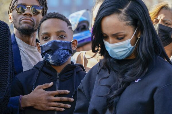 One of Dmx's sons, center, is joined by friends and family members during a prayer vigil for the rapper outside of White Plains Hospital, Monday, April 5, 2021, in White Plains, N.Y. Supporters and family of the rapper DMX have chanted his name and offered up prayers outside the hospital where he remains on life support. The 50-year-old was admitted to the hospital following a heart attack. (AP Photo/Mary Altaffer)