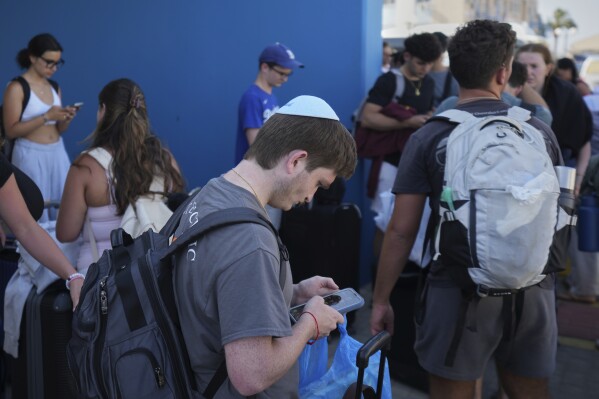 Evacuees from Israel arrive at the port of Larnaca, Cyprus, Wednesday, June 18, 2025. (AP Photo/Petros Karadjias)
