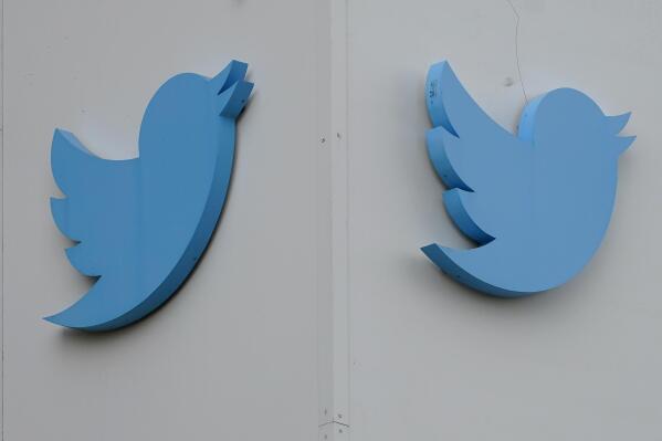 FILE - Twitter logos hang outside the company's offices in San Francisco, Monday, Dec. 19, 2022. Ella Irwin, a top Twitter executive responsible for safety and content moderation, has left the company. Her departure came after owner Elon Musk publicly complained about the platform’s handling of posts about transgender topics. (AP Photo/Jeff Chiu, File)