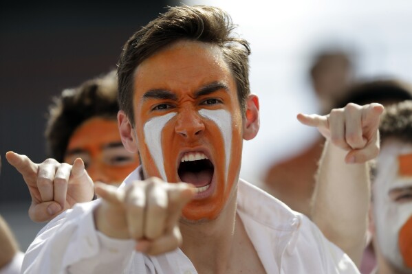 FILE - Texas fans cheer before an NCAA college football game against Baylor, Saturday, Oct. 13, 2018, in Austin, Texas. Baylor and Texas, whose campuses are 100 miles apart, have been conference foes since being the original formation of the SWC in 1915. (AP Photo/Eric Gay, File)