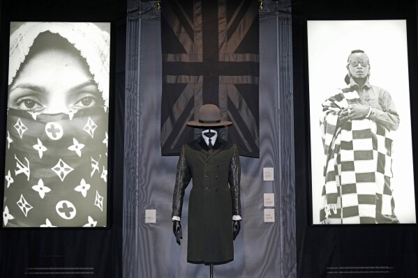 A black union jack shawl, Madhatter crown hat and Rudie coat designed by London-based art collective Art Comes First, are displayed during a preview of the exhibition titled 