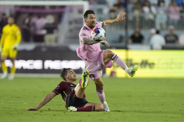 Atlanta United midfielder Santiago Sosa (5) defends against Inter Miami forward Lionel Messi (10) during the first half of a Leagues Cup soccer match, Tuesday, July 25, 2023, in Fort Lauderdale, Fla. (AP Photo/Lynne Sladky)
