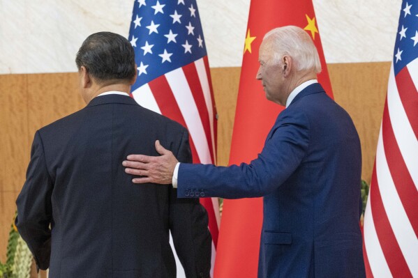 FILE - U.S. President Joe Biden, right, departs with Chinese President Xi Jinping for a meeting on the sidelines of the G20 summit meeting, Nov. 14, 2022, in Bali, Indonesia. (AP Photo/Alex Brandon, File)