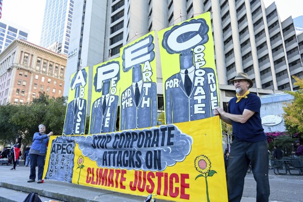 Demonstrators prepare to march in opposition to the APEC Summit Sunday, Nov. 12, 2023 in San Francisco. Hundreds of business executives, foreign press and world leaders will descend on San Francisco for the highly anticipated global trade summit. (AP Photo/ Noah Berger)