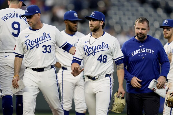 Kansas City Royals manager Matt Quatraro (33) leads starting pitcher Alec Marsh (48) off the field during the fifth inning of a baseball game against the Toronto Blue Jays Wednesday, April 24, 2024, in Kansas City, Mo. (AP Photo/Charlie Riedel)