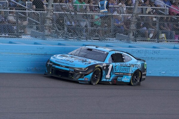Ross Chasten (1) drives down the frontstretch during a NASCAR Cup Series Championship auto race at Phoenix Raceway, Sunday, Nov. 5, 2023, in Avondale, Ariz. (AP Photo/Darryl Webb)