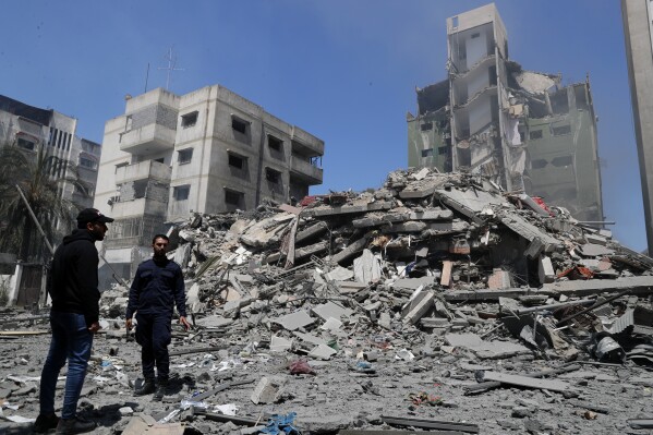 FILE - Hamas police officer stands guard amid the rubble of the Yazegi residential building that was destroyed by an Israeli airstrike, in Gaza City, Sunday, May 16, 2021. Israel's army announced Friday, July 7, 2023, that it has disciplined five officers, but would not file criminal charges, for their actions during Israel's 2021 war in the Gaza Strip — a conflict in which human rights advocates say Israel committed war crimes. (AP Photo/Adel Hana, File)