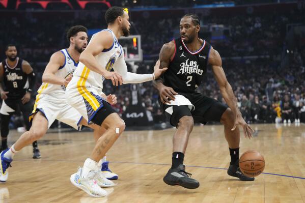Golden State Warriors' Stephen Curry, left, defends against Los Angeles Clippers' Kawhi Leonard during the first half of an NBA basketball game Wednesday, March 15, 2023, in Los Angeles. (AP Photo/Jae C. Hong)