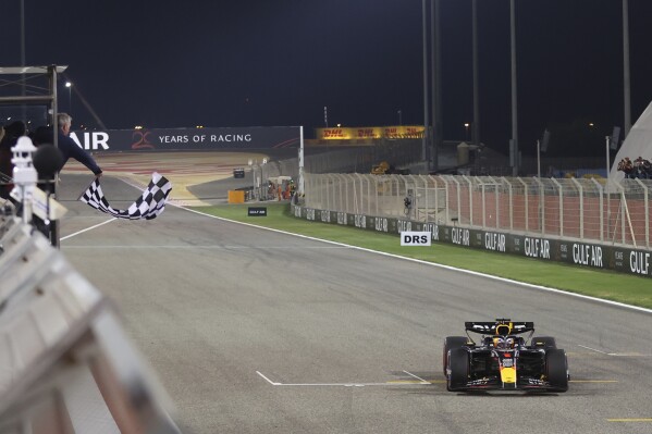 The checkered flag is waved as Red Bull driver Max Verstappen of the Netherlands crosses the finish line to take first place during the Formula One Bahrain Grand Prix at the Bahrain International Circuit in Sakhir, Bahrain, Saturday, March 2, 2024. (Ali Haider, Pool Photo via AP)