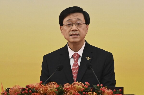 FILE- Hong Kong's Chief Executive John Lee gives a speech following a swearing-in ceremony to inaugurate the city's new government in Hong Kong on July 1, 2022. Hong Kong’s leader said Tuesday, Sept. 19, 2023 that the territory will tighten regulation of digital assets after police arrested six people following allegations of fraud at an unlicensed cryptocurrency exchange in the city. (Selim Chtayti/Pool Photo via AP, File)