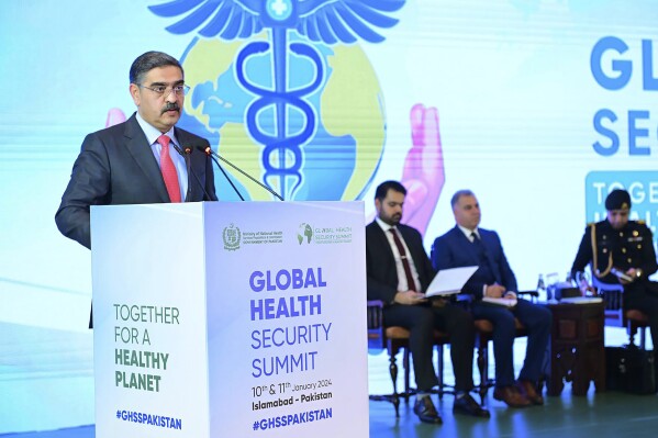 In this photo released by the Press Information Department, Pakistan's caretaker Prime Minister Anwaar-ul-Haq Kakar speaks, during the Global Heath Security Summit, in Islamabad, Pakistan, Wednesday, Jan. 10, 2024. Kakar called for unified efforts to tackle global infectious diseases like COVID-19 and emergencies caused by climate change, nearly 1 1/2-year after devastating floods killed 1,700 people in his nation. (Press Information Department via AP)