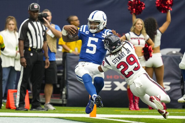 Indianapolis Colts quarterback Anthony Richardson (5) is hit by Houston Texans safety M.J. Stewart (29) as he runs for a touchdown in the first half of an NFL football game in Houston, Sunday, Sept. 17, 2023. (AP Photo/Eric Christian Smith)