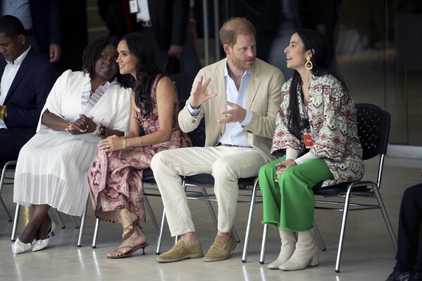 Prince Harry and Meghan attend a welcoming ceremony, at the Delia Zapata National Arts Center, flanked by Colombia's Vice President Francia Márquez, left, and director Xiomara Suescun, in Bogota, Colombia, Thursday, Aug. 15, 2024. (AP Photo/Ivan Valencia)