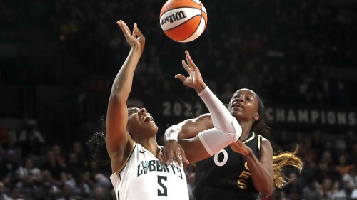 New York Liberty forward Kayla Thornton (5) is fouled by Las Vegas Aces guard Jackie Young (0) during the first half of a WNBA basketball game Thursday, June 29, 2023, in Las Vegas. (Steve Marcus/Las Vegas Sun via AP)