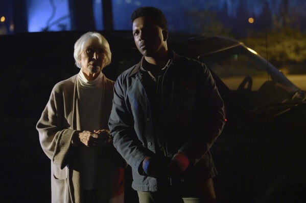 This image released by Universal Pictures shows Ellen Burstyn, left, and Leslie Odom, Jr. in a scene from "The Exorcist: Believer." (Anne Marie Fox/Universal Pictures via AP)