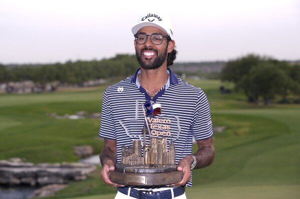Akshay Bhatia holds his trophy after winning the Texas Open golf tournament, Sunday, April 7, 2024, in San Antonio. Bhatia defeated Denny McCarthy in a playoff. (AP Photo/Eric Gay)
