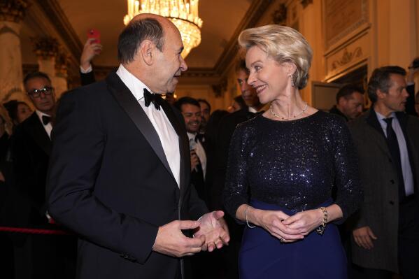 European Commission President Ursula von der Leyen, right, is received by La Scala Superintendent Dominique Meyer as she arrives for the premiere of Modest Mussorgsky's Boris Godunov in Milan, Italy, Wednesday, Dec. 7, 2022. Italy’s most famous opera house, Teatro alla Scala, opened its new season Wednesday with the Russian opera “Boris Godunov,” against the backdrop of Ukrainian protests that the cultural event is a propaganda win for the Kremlin during Russia’s invasion of Ukraine. (AP Photo/Antonio Calanni)