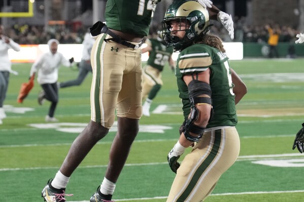 Colorado State wide receiver Tory Horton, left, congratulates tight end Dallin Holker after he caught a touchdown pass to tie the score in the second half of an NCAA college football game against Boise State on Saturday, Oct. 14, 2023, in Fort Collins, Colo. (AP Photo/David Zalubowski)