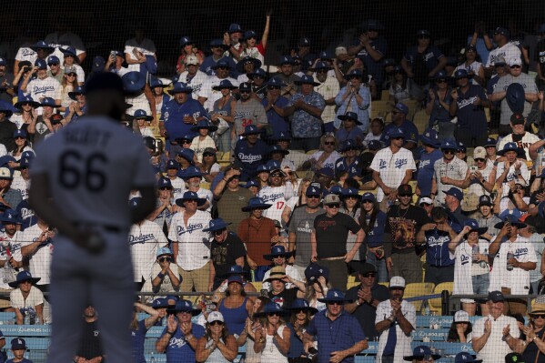 Fans cheer as Los Angeles Dodgers pitcher Tanner Scott prepares to throw during the ninth inning of a baseball game against the San Francisco Giants in Los Angeles, Saturday, June 14, 2025. (AP Photo/Jessie Alcheh, File)