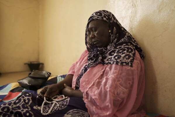 Seynabou Diop looks on as she holds her prayer beads after talking about her son, Khadim Ba, 21, who died during the protests earlier this month in Dakar, Senegal, Thursday, June 15, 2023. "If I had known (he was going to protest), Khadim would never have taken part," said Diop. "I want (the government) to meet the expectations of young people, the government has an obligation to help (them)," she said. (AP Photo/Leo Correa)