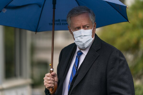 In this Oct. 25, 2020, photo, White House chief of staff Mark Meadows responds to reporters questions outside the West Wing on the North Lawn of the White House in Washington. A multi-state coronavirus surge in the countdown to Election Day has exposed a clear split between President Donald Trump’s bullish embrace of a return to normalcy and urgent public warnings from the government’s top health officials. (AP Photo/Manuel Balce Ceneta)