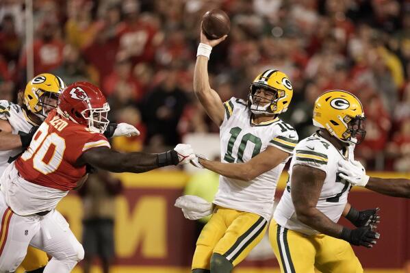 Green Bay Packers quarterback Jordan Love, right, throws under pressure from Kansas City Chiefs defensive tackle Jarran Reed (90) during the second half of an NFL football game Sunday, Nov. 7, 2021, in Kansas City, Mo. (AP Photo/Charlie Riedel)