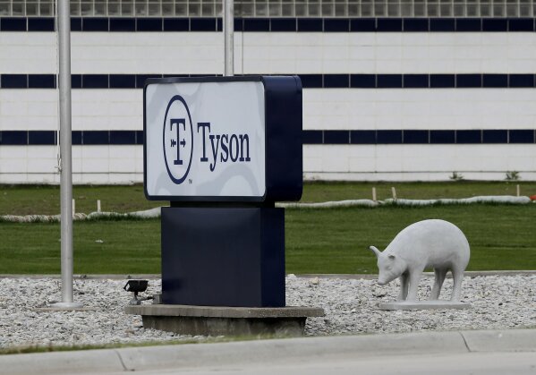 In this Friday, May 1, 2020, photo, a sign stands in front of the Tyson Foods plant in Waterloo, Iowa. The coronavirus is devastating the nation’s meatpacking communities — places like Waterloo and Sioux City in Iowa, Grand Island, Neb., and Worthington, Minn. Within weeks, the outbreaks around slaughterhouses have turned into full-scale disasters. (AP Photo/Charlie Neibergall)