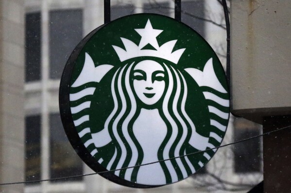 FILE - The Starbucks logo is seen on a shop, March 14, 2017, in downtown Pittsburgh. Starbucks is increasing pay and benefits for most of its U.S. hourly workers after ending its fiscal year with record sales. But the company said Monday, Nov. 6, 2023, that unionized workers won't be eligible for some of those perks, a sign of the continuing tension between the Seattle coffee giant and the union trying to organize its U.S. stores. (AP Photo/Gene J. Puskar, File)