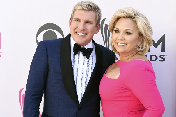 FILE - Todd Chrisley, left, and his wife, Julie Chrisley, pose for photos at the 52nd annual Academy of Country Music Awards on April 2, 2017, in Las Vegas. Todd and Julie Chrisley, who are in prison after being convicted on federal charges of bank fraud and tax evasion, are challenging aspects of their convictions and sentences in a federal appeals court.(Photo by Jordan Strauss/Invision/AP, File)