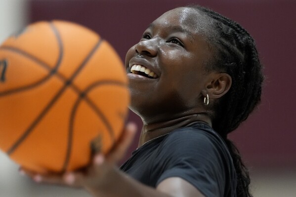 Shay Ijiwoye, who plays basketball at Desert Vista High in Phoenix and has committed to Stanford University, works out Monday, March 18, 2024, in Chandler, Ariz. Iowa’s Caitlin Clark has reshaped women's college basketball and the perception of it. Up-and-coming players have taken notice, working to extend their range to be like her. (AP Photo/Matt York)