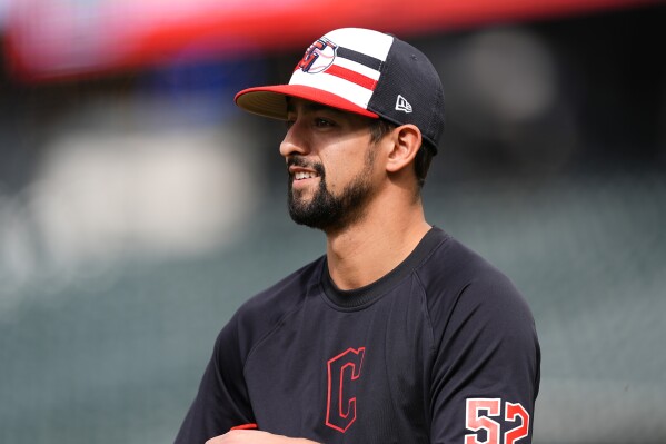 Cleveland Guardians pitcher Nick Sandlin heads out to warm up before the team's baseball game against the Colorado Rockies on Wednesday, May 29, 2024, in Denver. (AP Photo/David Zalubowski)