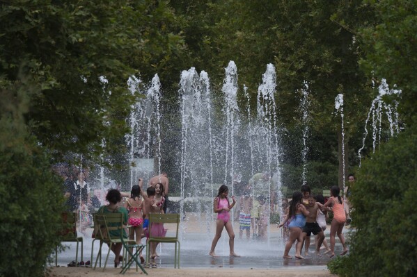 Children play with water on a fountain during a heat wave at Stavros Niarchos foundation Cultural Center, in Athens, on Thursday, June 13, 2024. Temperatures are expected to exceed 40 C (104 F) on Thursday in much of central and southern Greece, including greater Athens, the Cyclades and Crete. The ancient Acropolis site was closed for second day to the public for five hours due to a heat wave (AP Photo/Petros Giannakouris)