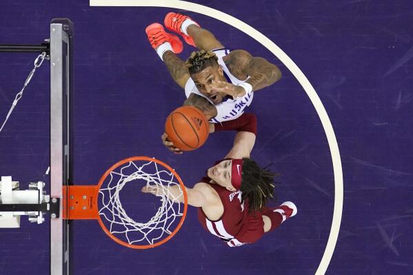 Washington's Nate Roberts, top, grabs a rebound next to Washington State's Tyrell Roberts during the first half of an NCAA college basketball game Saturday, Feb. 26, 2022, in Seattle. (AP Photo/Elaine Thompson)