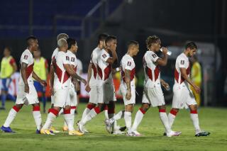 Peru's soccer players leave the field at the end of the first half during a qualifying soccer match for the FIFA World Cup Qatar 2022 against Paraguay at the Defensores del Chaco stadium, in Asuncion, Paraguay, Thursday, Oct.8, 2020. (AP Photo/Jorge Saenz)