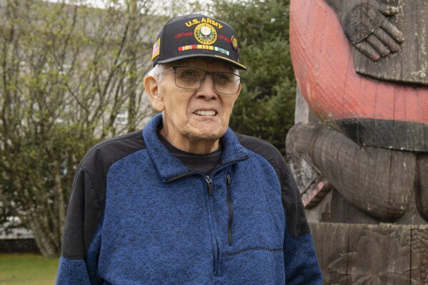 George Bennett stands in front of a totem on the Southeast Alaska Health Consortium campus in Sitka, Alaska, Monday, April 28, 2025. (James Poulson/The Daily Sitka Sentinel via AP)