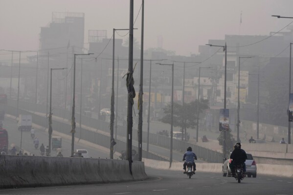 Traffic moves slow on a road as smog envelops the areas of Lahore, Pakistan, Nov. 2, 2023. (AP Photo/K.M. Chaudary, File)