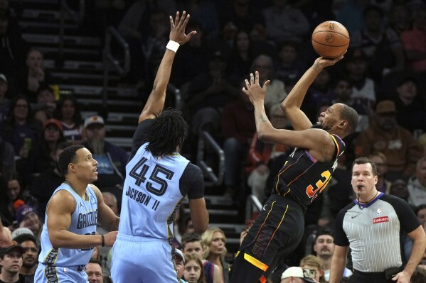 Phoenix Suns forward Kevin Durant (35) shoots over Memphis Grizzlies guard Desmond Bane and forward GG Jackson (45) during the second half of an NBA basketball game, Tuesday, Feb. 11, 2025, in Phoenix. Memphis won 119-112. (AP Photo/Rick Scuteri)