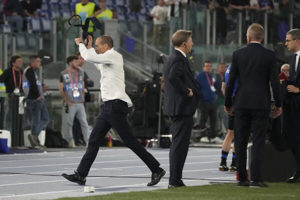 FILE - Juventus' head coach Massimiliano Allegri throws away his tie in anger as he leaves the pitch after getting a red card during the Italian Cup final soccer match between Atalanta and Juventus at Rome's Olympic Stadium, Wednesday, May 15, 2024. Juventus fired coach Massimiliano Allegri on Friday, May 17, 2024 for his ugly outburst toward the referees in the Italian Cup final. Juventus has two games left in Serie A but Allegri was due to miss them following a two-game suspension for his Cup final behavior on Wednesday. (AP Photo/Gregorio Borgia)