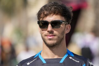 Alpine driver Pierre Gasly of France walks through the paddock during Formula One pre season testings at the Bahrain International Circuit in Sakhir, Bahrain, Friday, Feb. 23, 2024. (AP Photo/Darko Bandic)