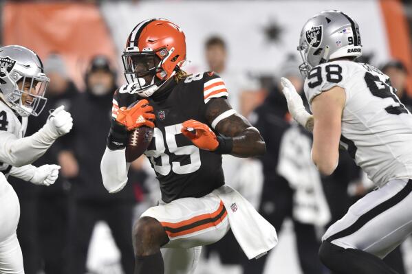 Cleveland Browns tight end David Njoku (85) runs against Las Vegas Raiders safety Johnathan Abram (24) and defensive end Maxx Crosby (98) after a catch during the second half of an NFL football game, Monday, Dec. 20, 2021, in Cleveland. (AP Photo/David Richard)