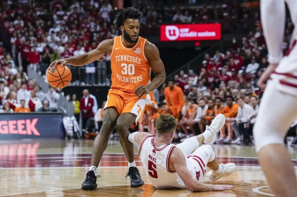 Tennessee's Josiah-Jordan James (30) fouls Wisconsin's Tyler Wahl (5) during the first half of an NCAA college basketball game Friday, Nov. 10, 2023, in Madison, Wis. (AP Photo/Andy Manis)