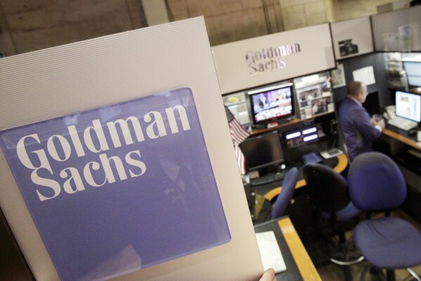 FILE - A trader works in the Goldman Sachs booth on the floor of the New York Stock Exchange, March 15, 2012. Goldman Sachs will report first quarter earnings later Thursday April 17, 2014. Goldman Sachs said Monday it saw a double-digit rise in its first-quarter profits, lifted broadly by the stock and bond markets’ performances in the first months of the year. The New York-based investment bank posted net income of $4.13 billion, up 28% from a year earlier. The company earned $11.67 a share for the quarter, well above analysts expectations. (AP Photo/Richard Drew, File)