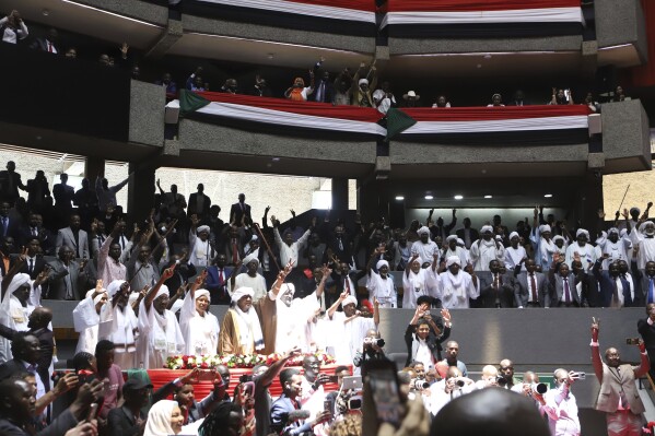 Delegates sing during a planned signing ceremony of the Sudan Founding Charter aimed at establishing a unity government involving leaders of political forces, armed groups, and the Rapid Support Forces (RSF) at the Kenyatta International Convention Centre (KICC) in Nairobi, on Feb. 18, 2025. (AP Photo/Andrew Kasuku)