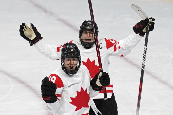 Canada's Brianne Jenner (19) celebrates with Marie-Philip Poulin (29) after Jenner scored a goal against the United States during a preliminary round women's hockey game at the 2022 Winter Olympics, Tuesday, Feb. 8, 2022, in Beijing. (AP Photo/Petr David Josek)